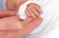 Photo of a tiny baby's hand.