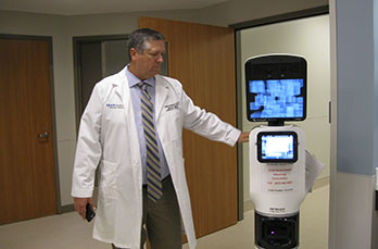 Photo of a doctor demonstrating how a machine works