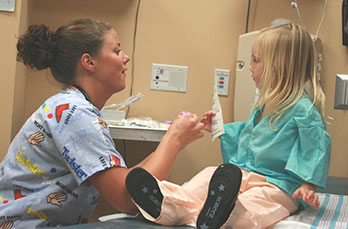 Photo of an NCH nurse and child.